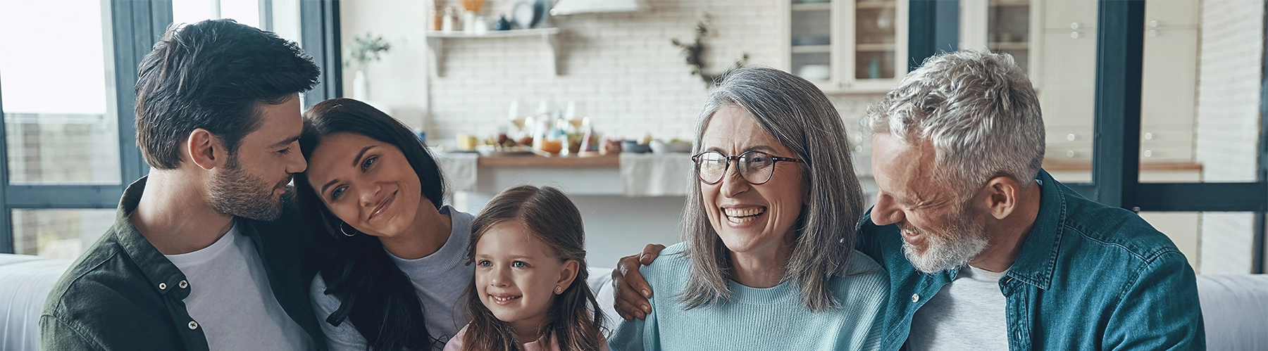happy family spending time together and smiling while sitting on the sofa at home