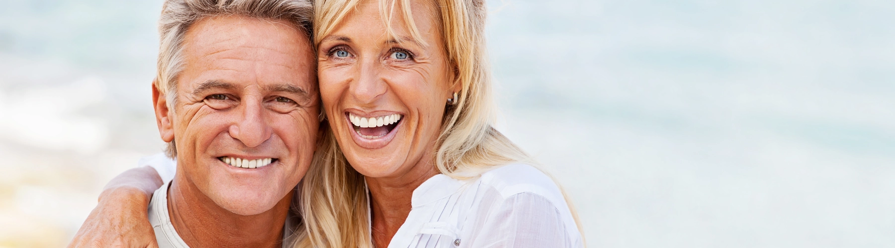 older couple laughing and smiling and hugging each other