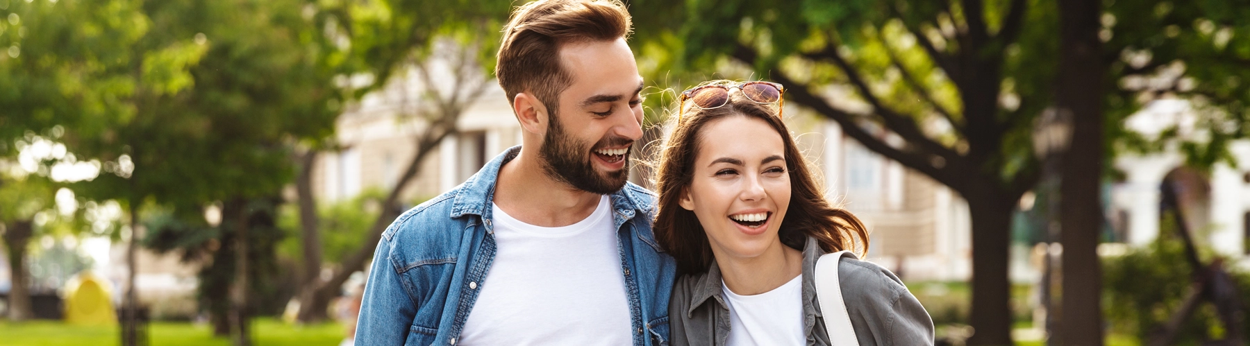 Beautiful young couple in love walking outdoors at the city street