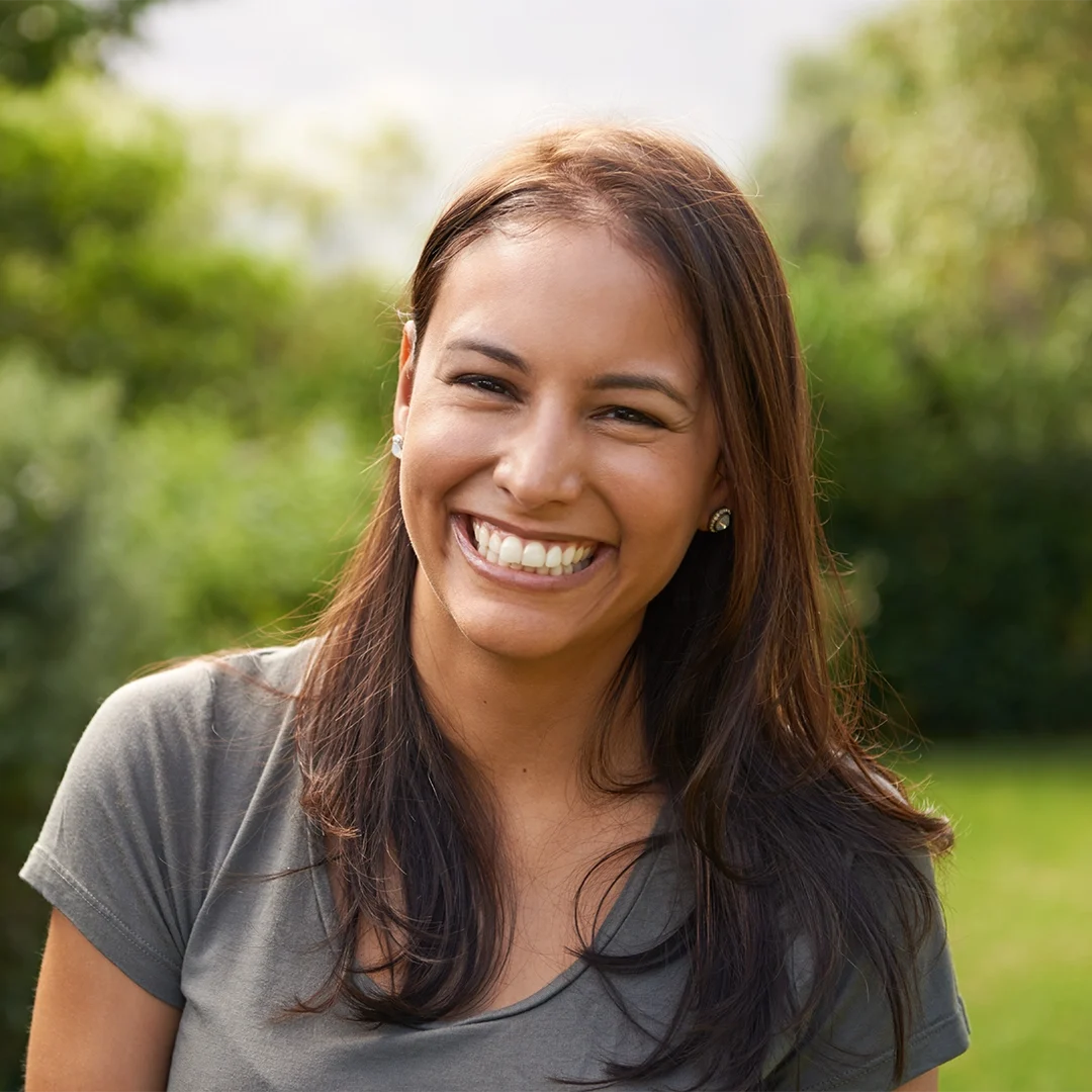 Woman smiling confidently after natural-looking dental fillings treatment