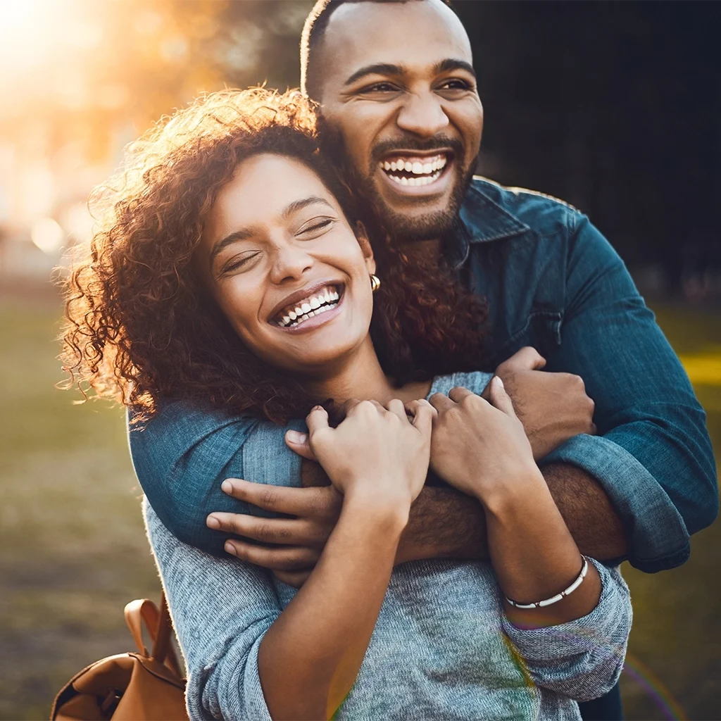 Happy couple smiling comfortably after oral appliance therapy for better sleep