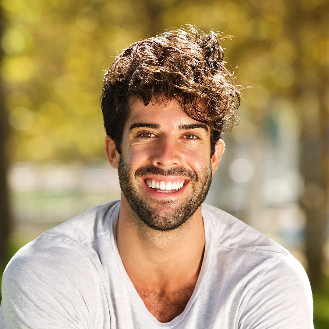 Man smiling with healthy gums after professional periodontal care treatment