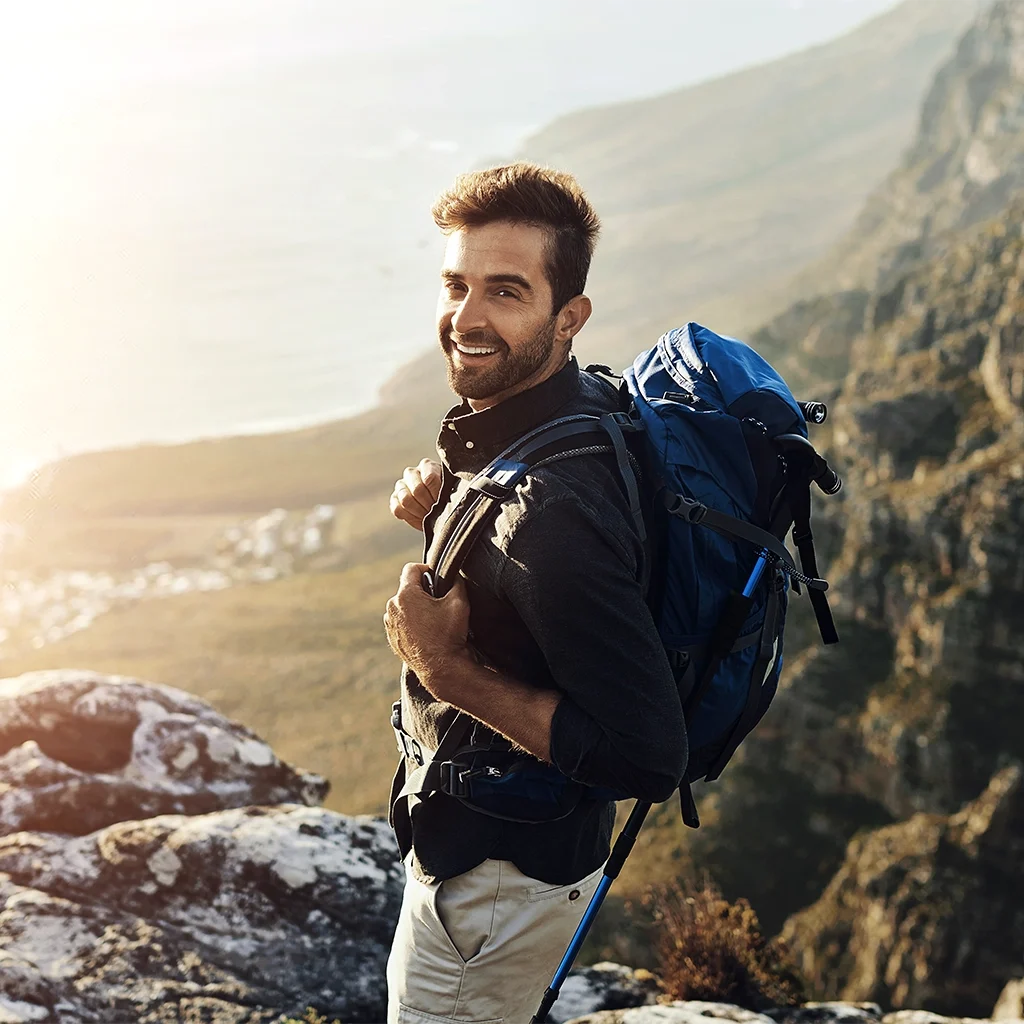 Man smiling confidently after pain relief with root canal therapy treatment