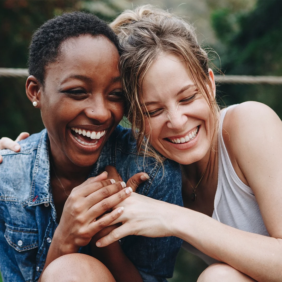 Friends smiling confidently after comfortable tooth extractions and recovery